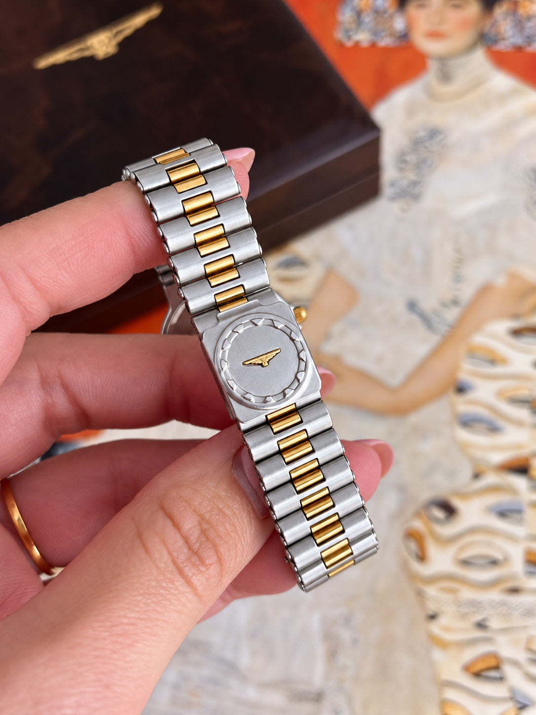 Longines Conquest two tone bracelet with gold tone centre links and a signed folding clasp bearing the winged hourglass emblem.