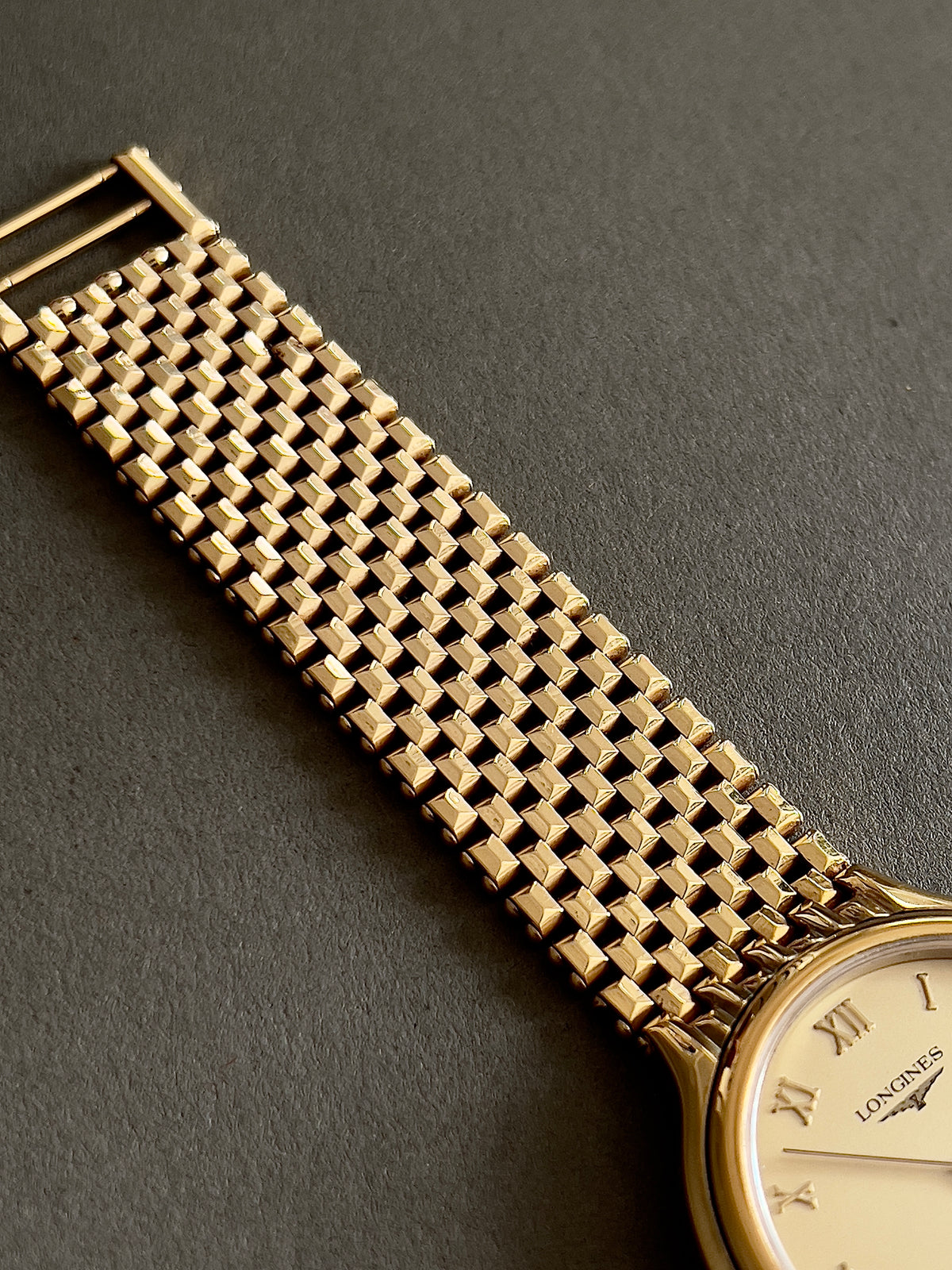 Longines Cosmopolitan Gold Roman Dial Unisex Watch — close view of dial and textured links.