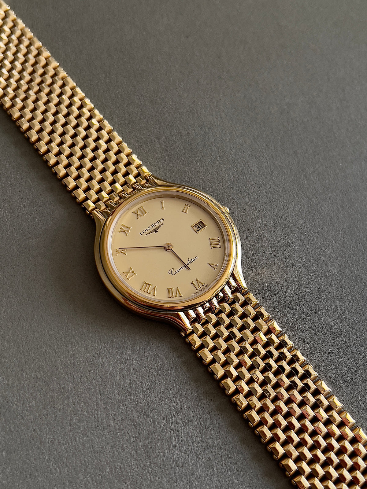 Longines Cosmopolitan Gold Roman Dial Unisex Watch — full watch and pyramid patterned bracelet.