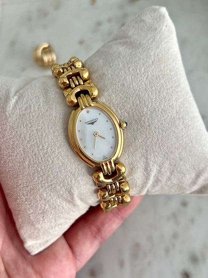 Longines Equestrian L6.132.2 gold-tone horseshoe bracelet watch shown on the wrist