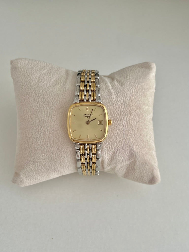 Longines Flagship women’s watch with a champagne dial, gold tone bezel and two tone bracelet shown from the front.