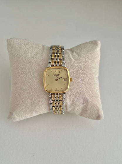 Longines Flagship women’s watch with a champagne dial, gold tone bezel and two tone bracelet shown from the front.