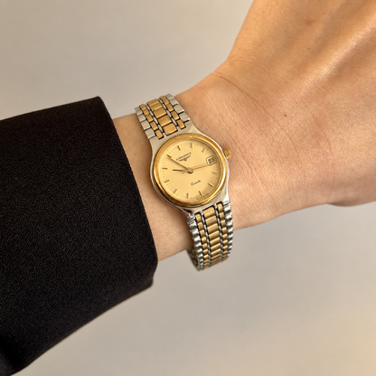 Longines Flagship two tone bracelet watch worn on wrist with a subtle warm gilded glow