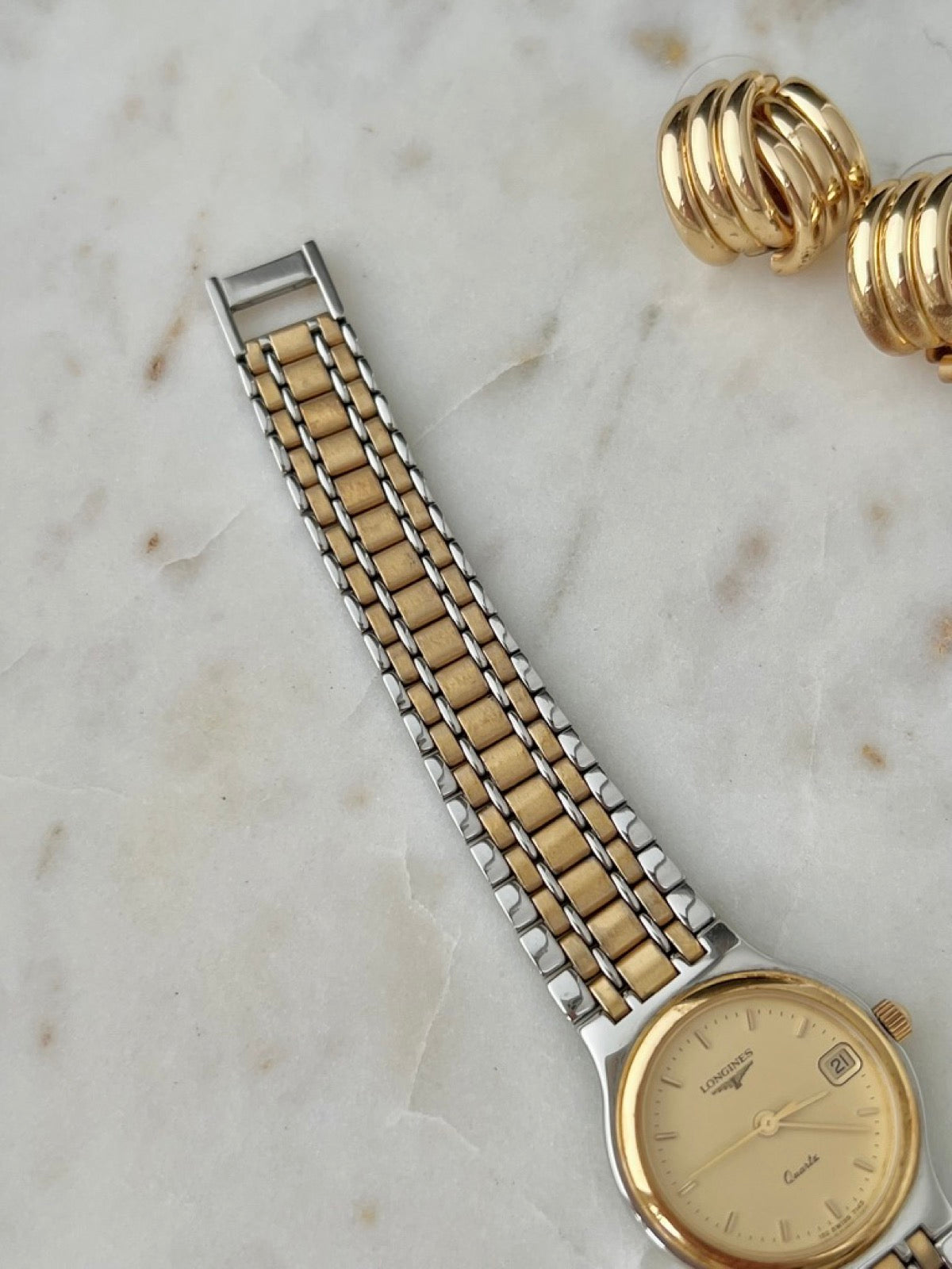 Second angled view of the Longines Flagship champagne dial and bracelet