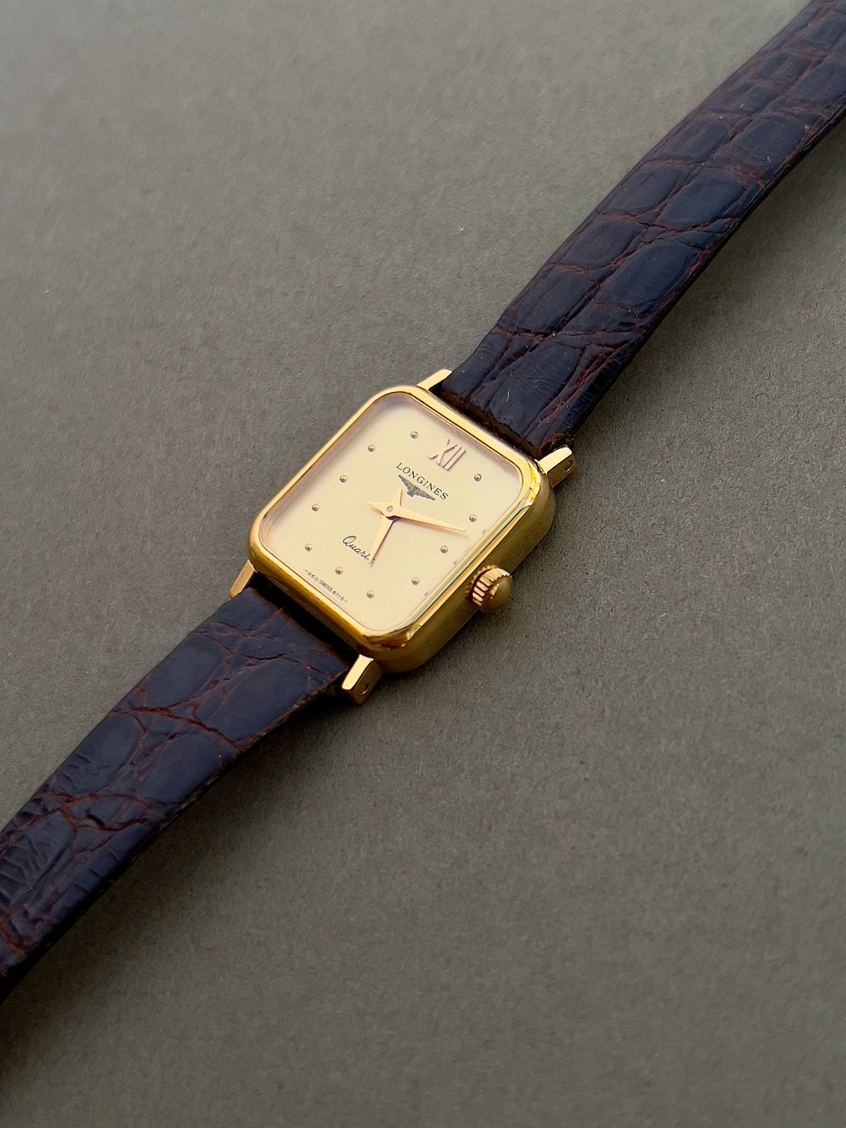 Longines Gold Toned Soft Rectangular Women's Watch, case profile of a vintage women's watch at Gilded Hour.