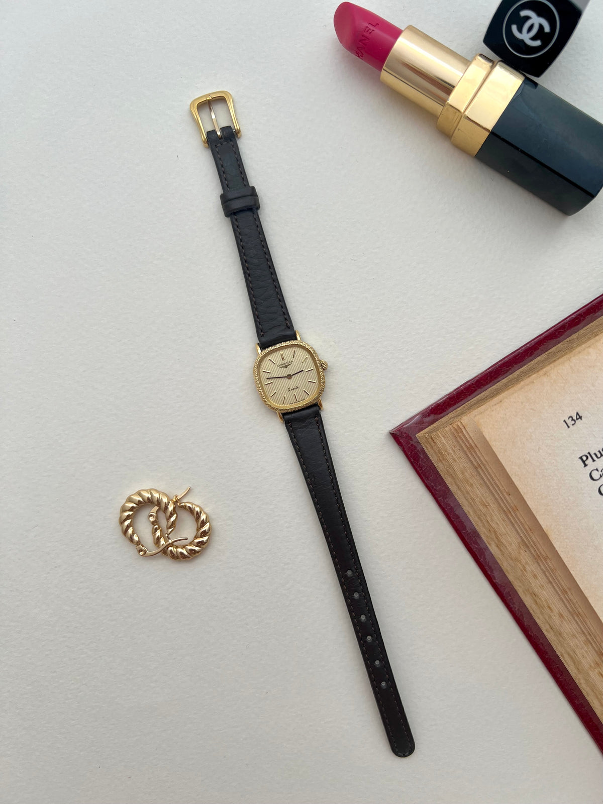 Detail of the black aftermarket leather strap fitted to the Longines gold cushion watch.