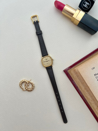 Detail of the black aftermarket leather strap fitted to the Longines gold cushion watch.