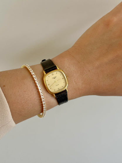 Longines Cushion Champagne Stripe Women’s Watch — Worn on the wrist with a gold bracelet