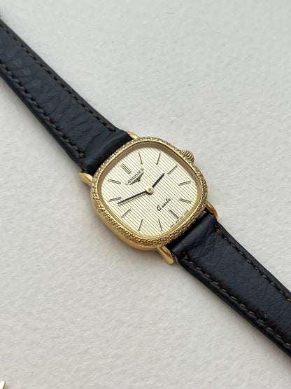 Close-up of the Longines cushion watch caseback and gold-tone case.