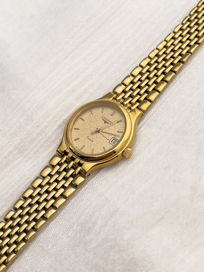 Longines round gold watch with integrated rice-link bracelet and baton markers.