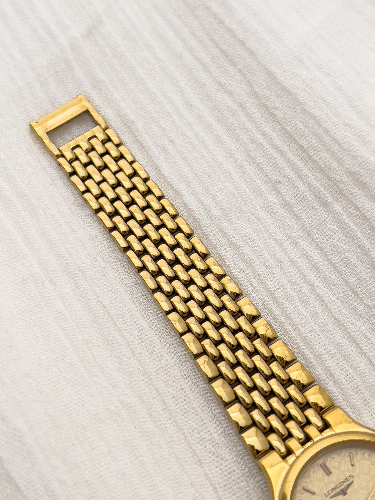 Longines gold-tone ladies watch with geometric patterned dial and original bracelet.