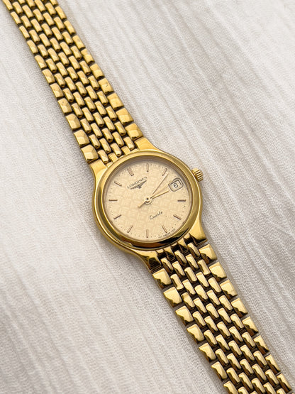 Gold-tone Longines women's quartz watch with patterned dial and date window.