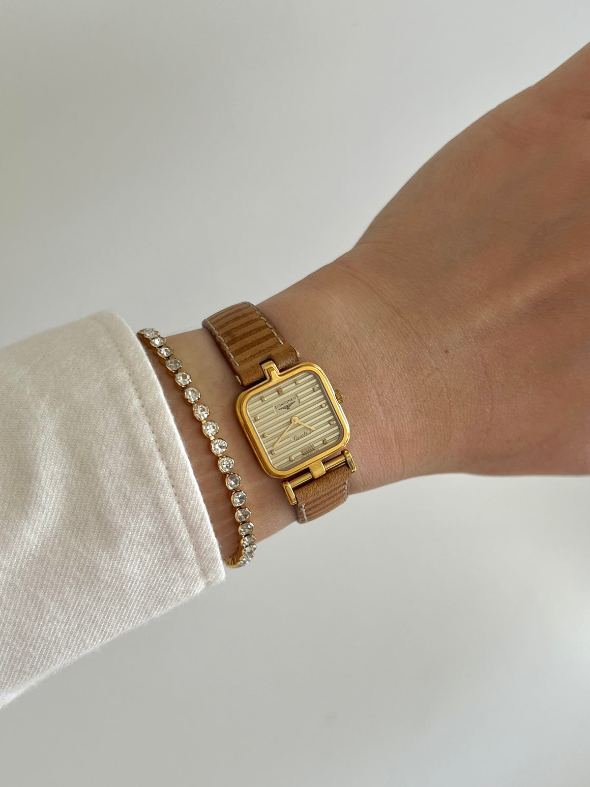 Detail of the Longines asymmetrical stepped lugs and ridged dial.