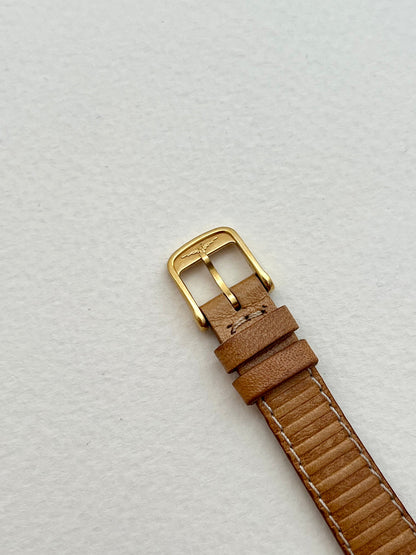 Side profile of the Longines gold-tone case and asymmetrical strap lugs.