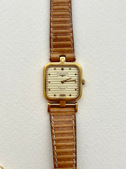 Close-up of the Longines champagne dial with raised horizontal ridges.