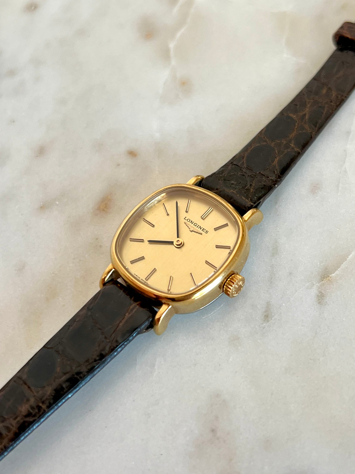 Longines Gold Round Champagne Dial watch — angled dial