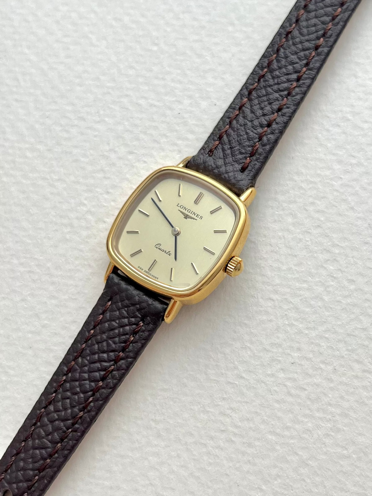Longines Champagne Dial Gold Cushion Leather watch: angled view of the dial and case.