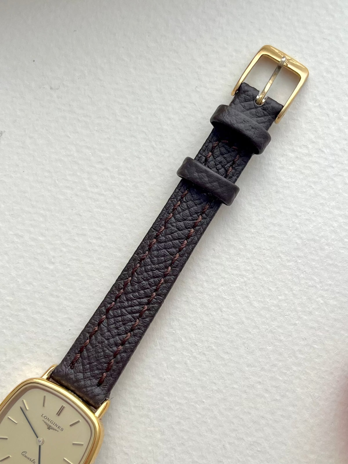 Longines Champagne Dial Gold Cushion Leather watch: strap and buckle detail.
