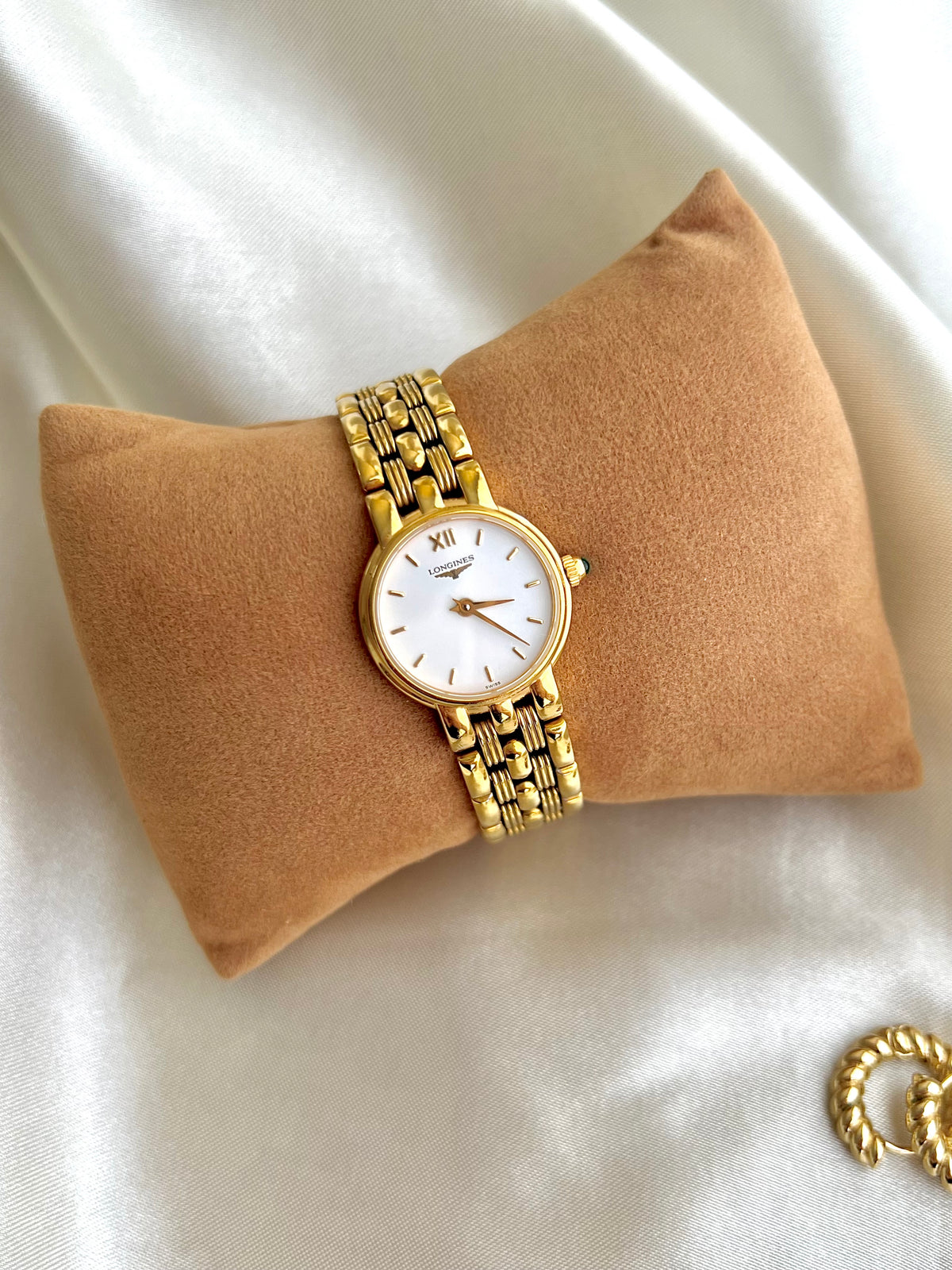 Longines Green Stone Crown Gold Bracelet watch L6.205.2: front view on a display cushion.