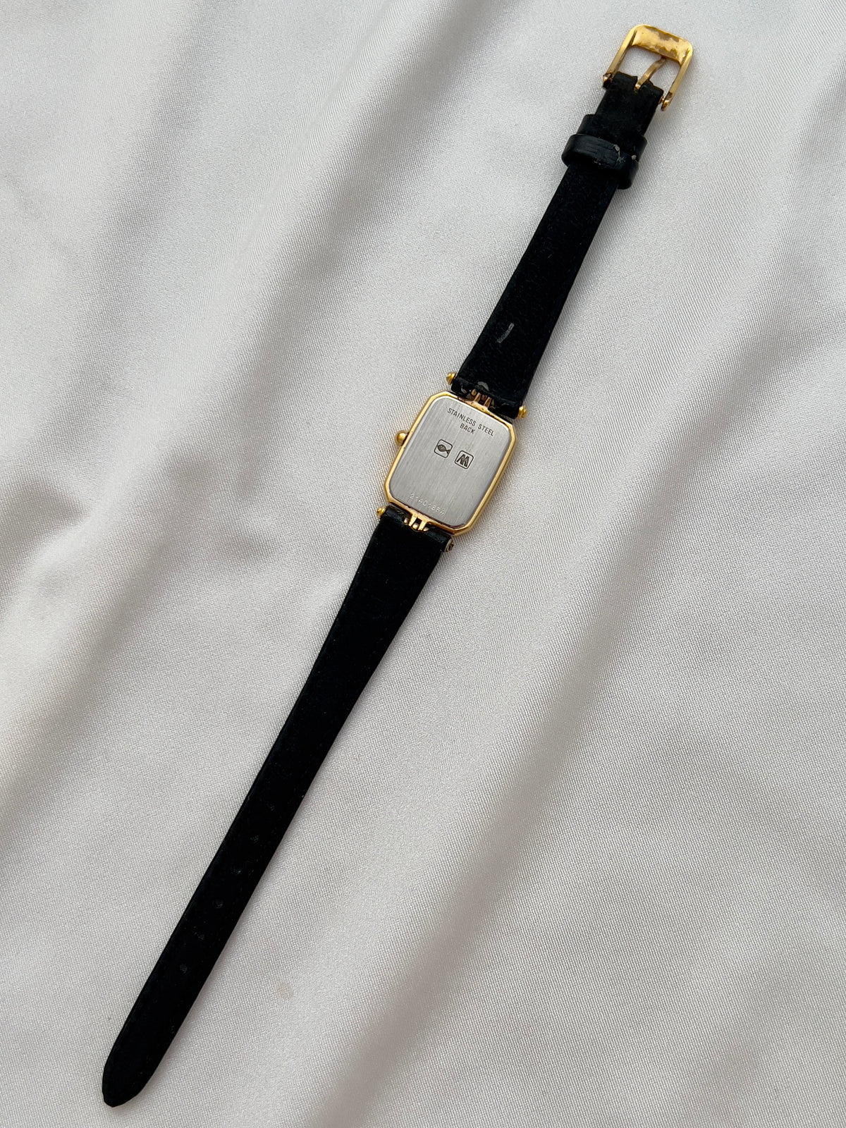 Longines Gold Toned Rectangular Womans Watch with Intricate Details, dial close up of a vintage women's watch at Gilded Hour.