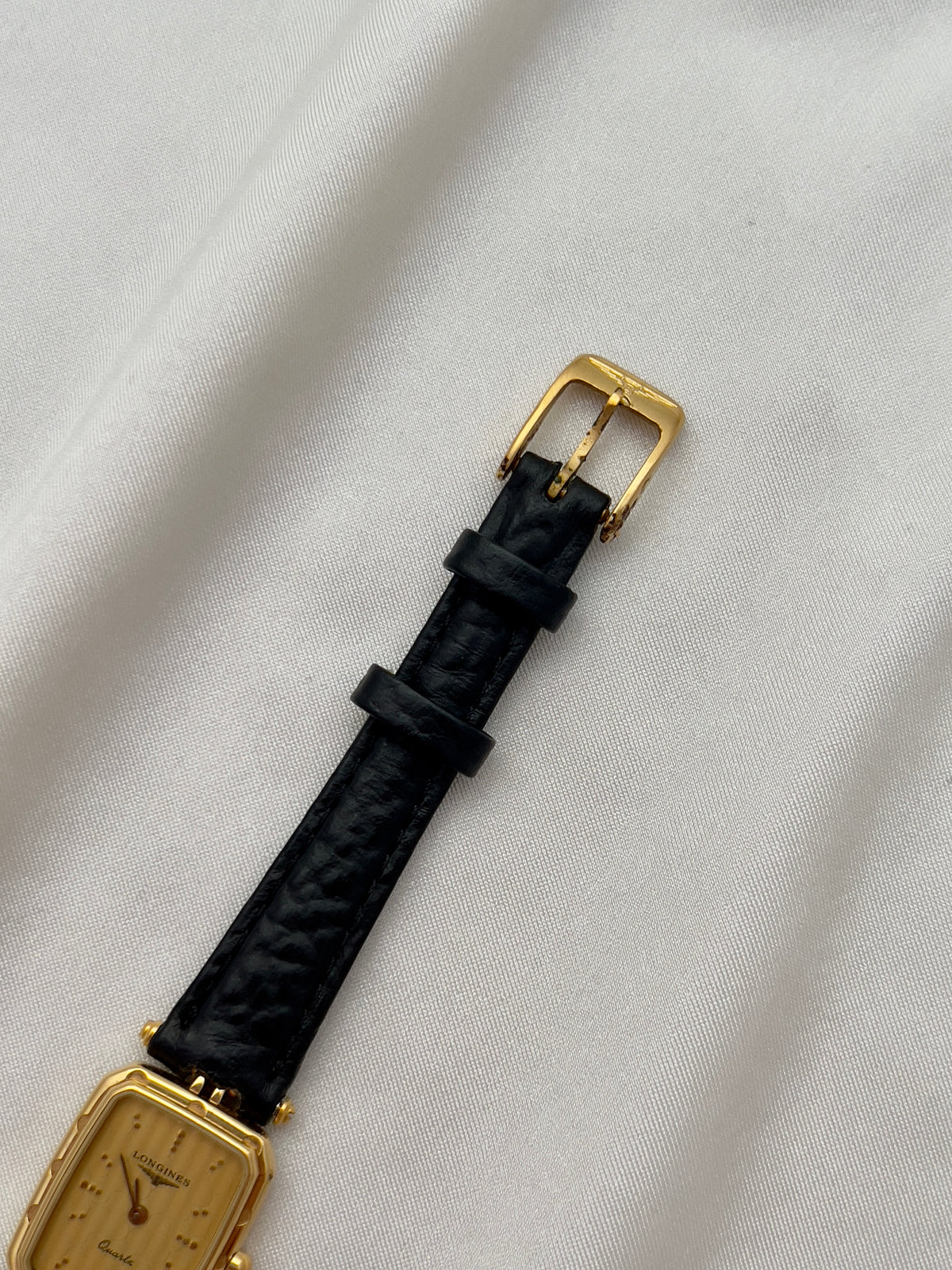 Longines Gold Toned Rectangular Womans Watch with Intricate Details, wrist shot of a vintage women's watch at Gilded Hour.
