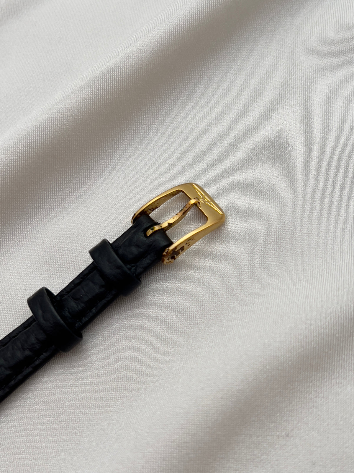 Longines Gold Toned Rectangular Womans Watch with Intricate Details, case profile of a vintage women's watch at Gilded Hour.