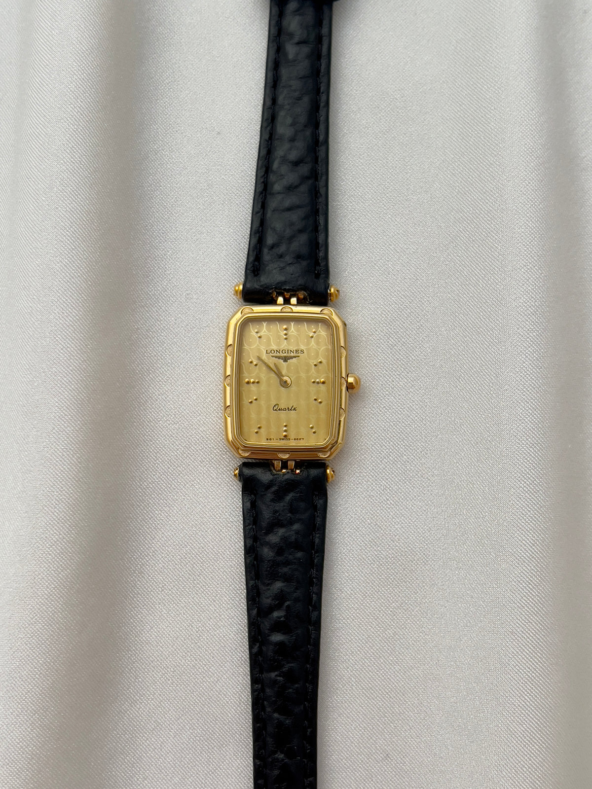 Longines Gold Toned Rectangular Womans Watch with Intricate Details, caseback detail of a vintage women's watch at Gilded Hour.