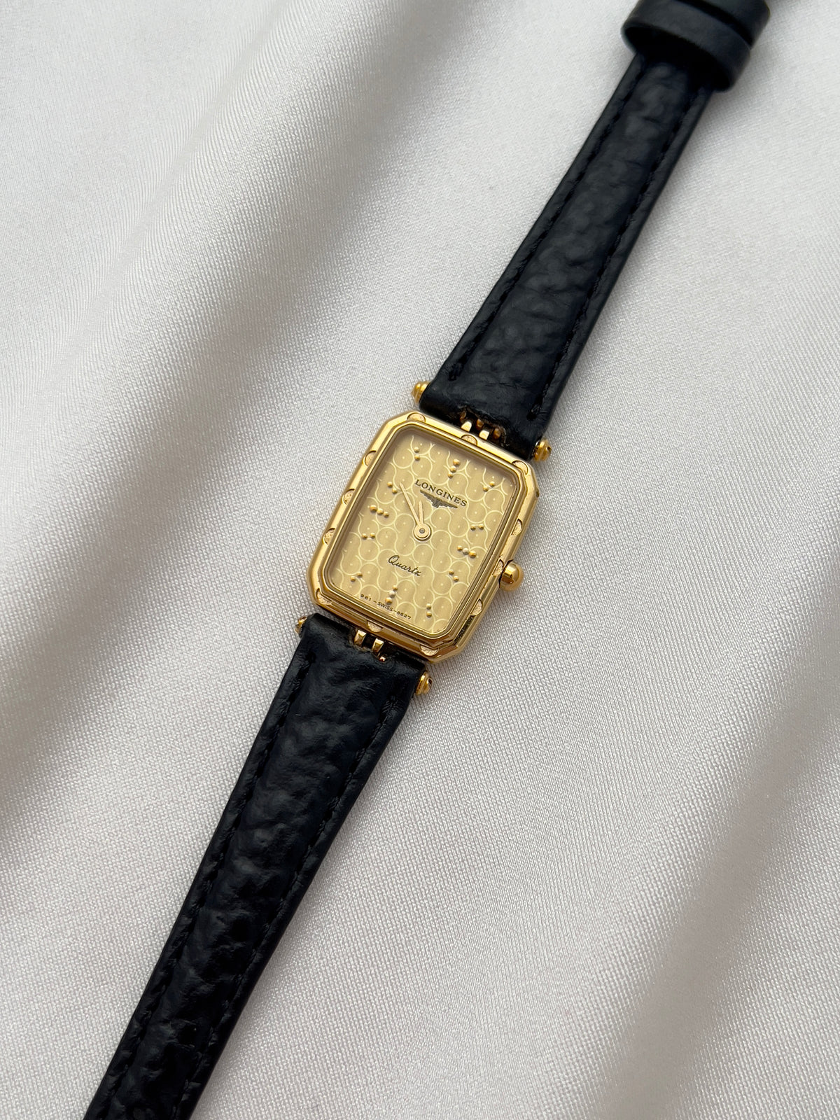 Longines Gold Toned Rectangular Womans Watch with Intricate Details, dial close up of a vintage women's watch at Gilded Hour.