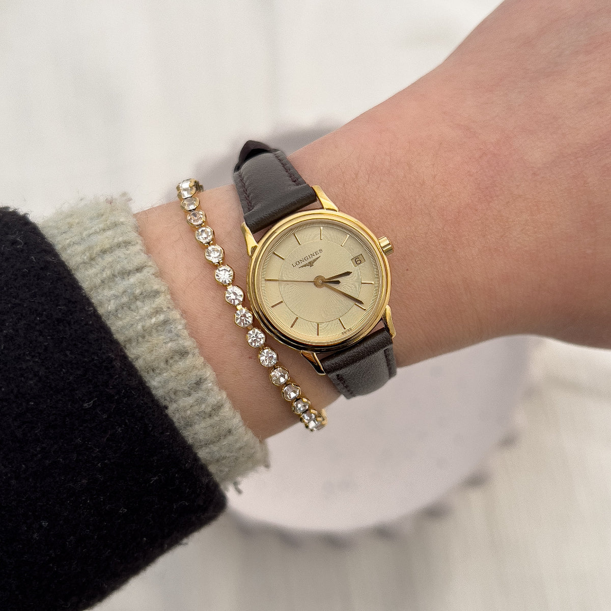Front view of the Longines La Grande Classique gold-tone watch with champagne dial and leather strap.