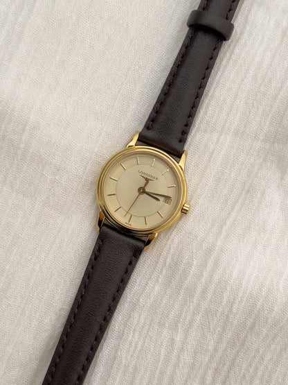 Longines gold-tone ladies watch with champagne dial and discreet date display.