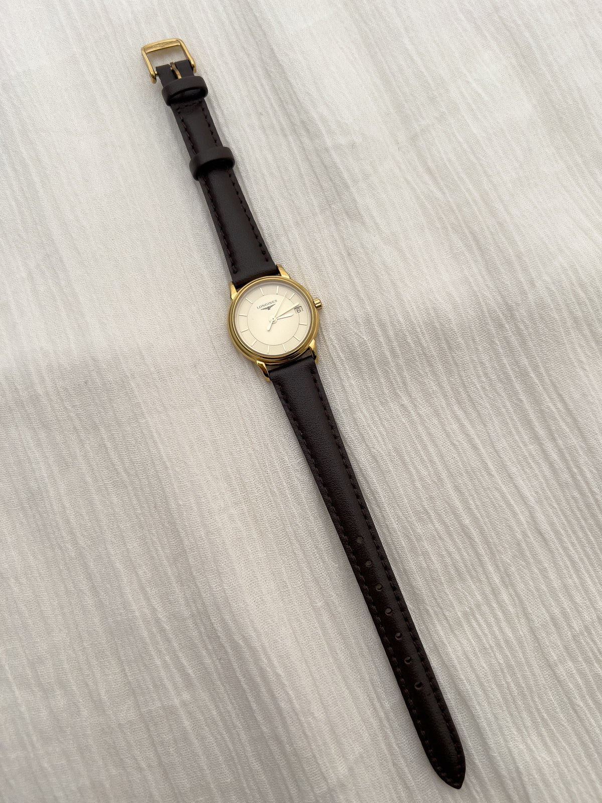 Close-up of the patterned champagne dial on the Longines La Grande Classique watch.