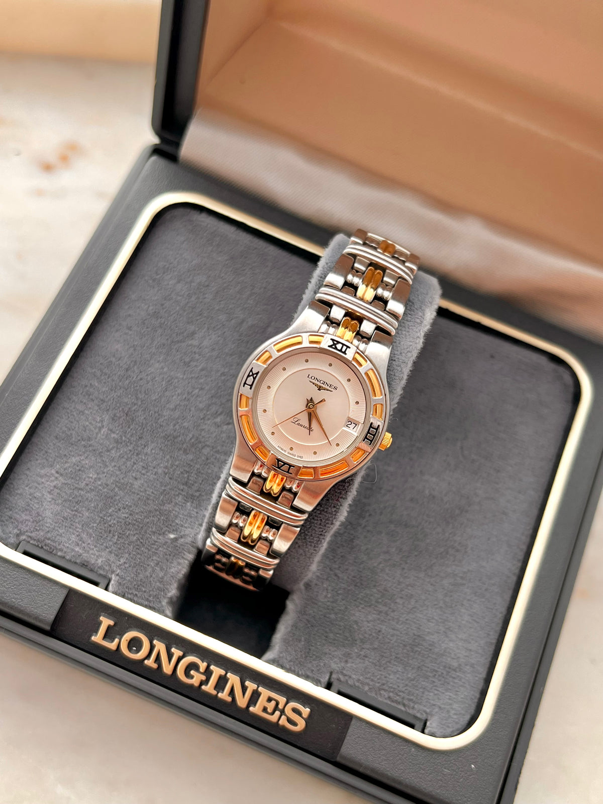 Longines Laureate Roman Bezel Two Tone watch: watch displayed in a Longines box.