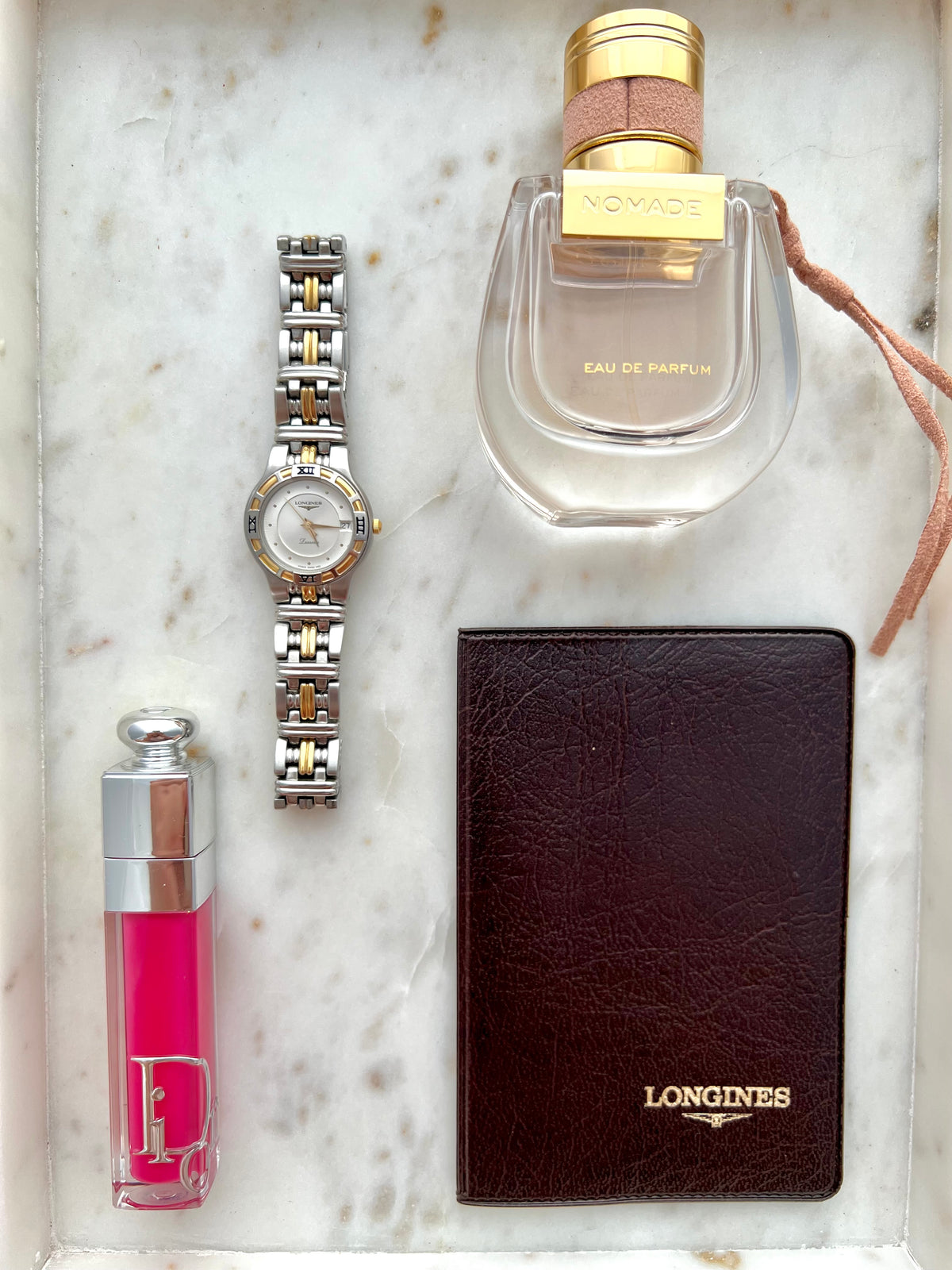 Longines Laureate Roman Bezel Two Tone watch: watch arranged with styling props.