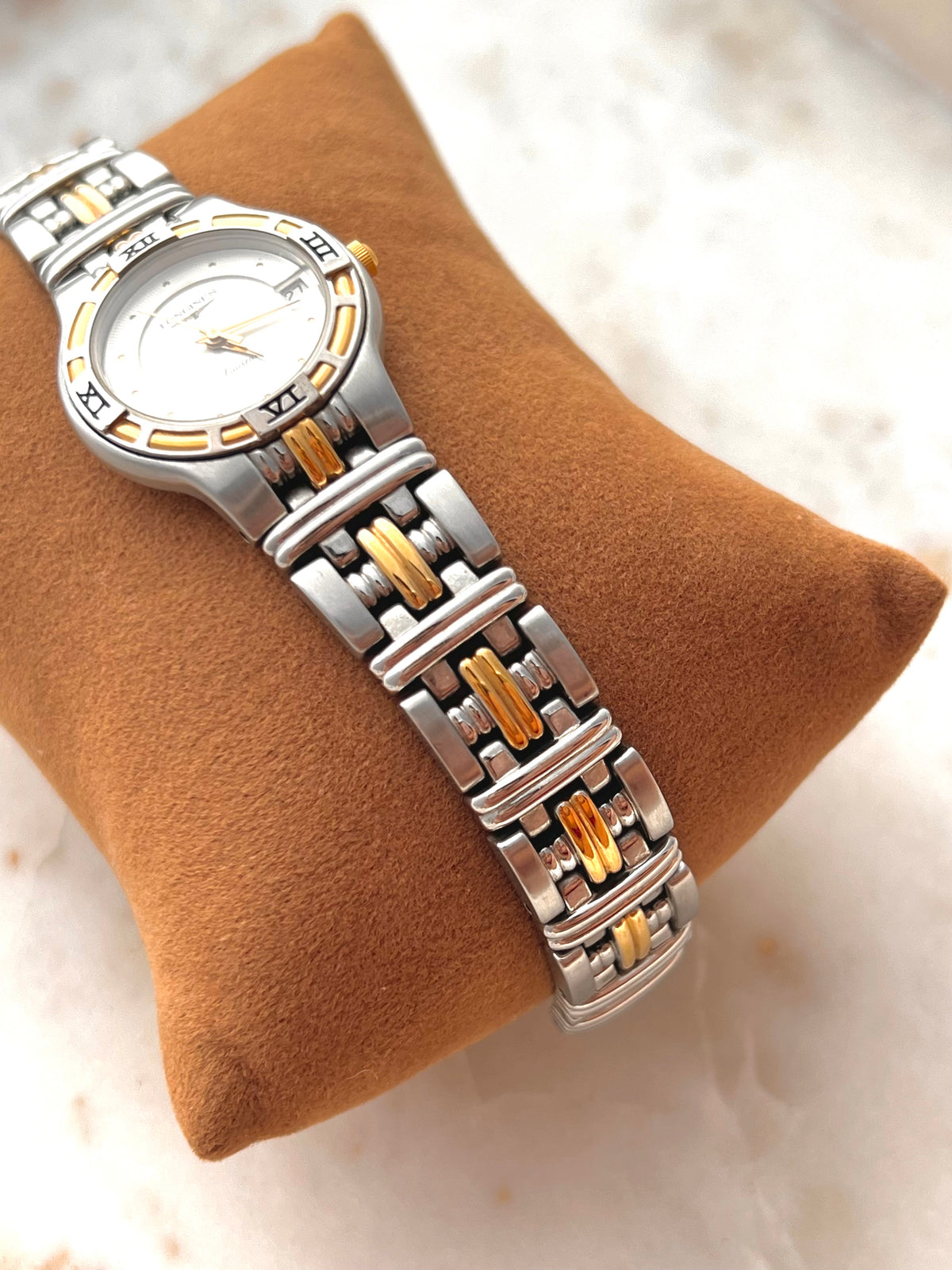 Longines Laureate Roman Bezel Two Tone watch: angled view of the dial and case.