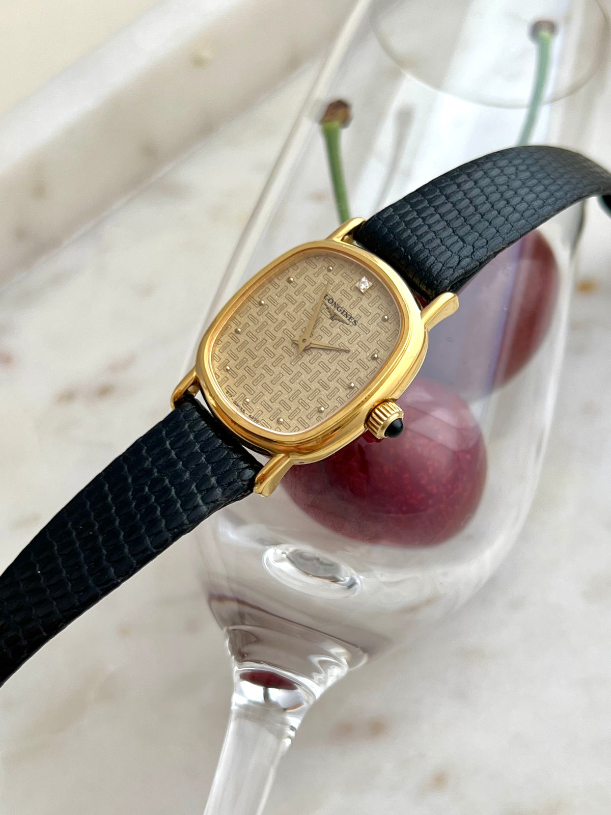 Longines Oblong Patterned Dial Women’s Watch — Side view of the curved case and dark stone crown