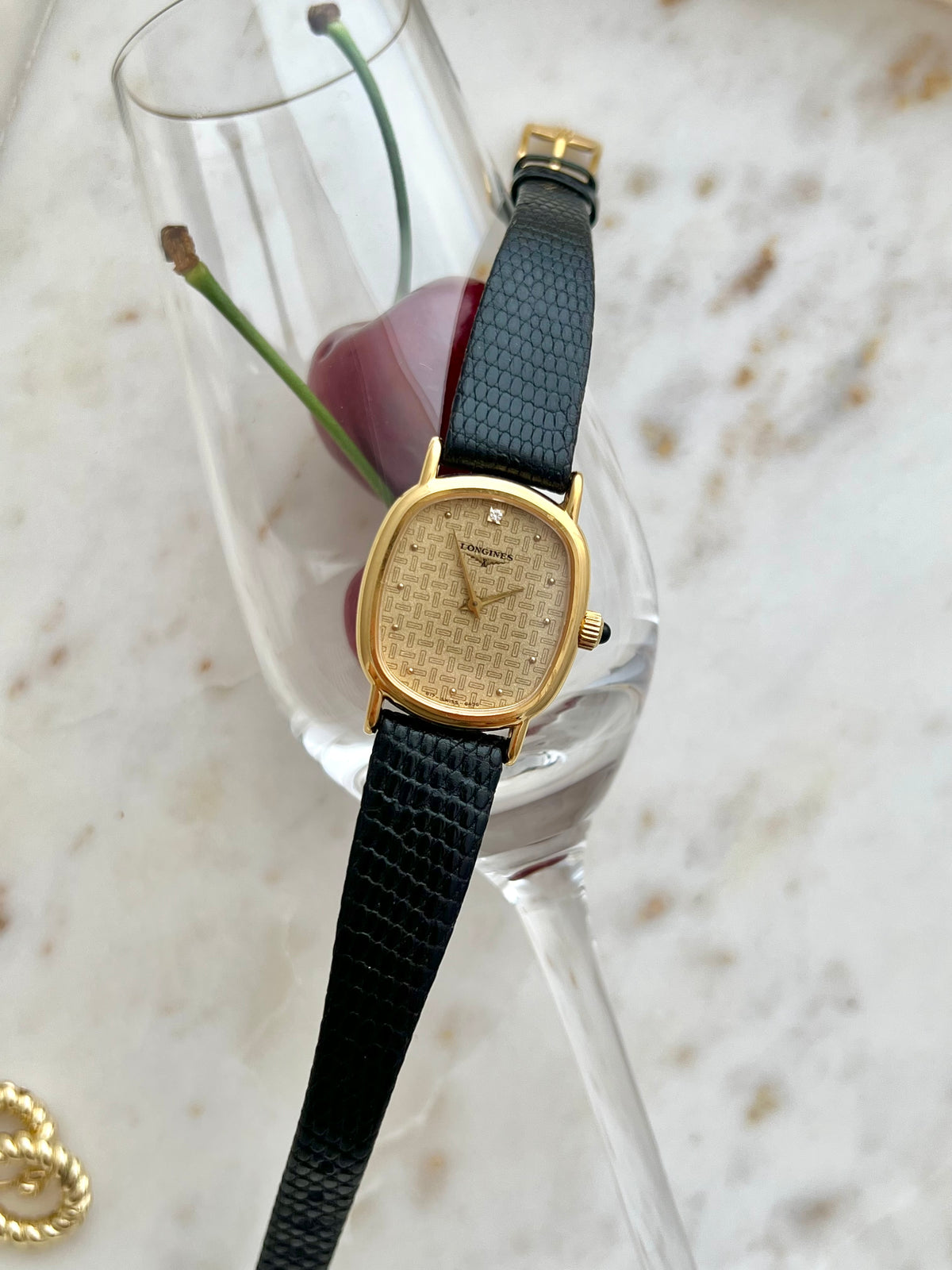 Longines Oblong Patterned Dial Women’s Watch — Closer full view across a glass of cherries