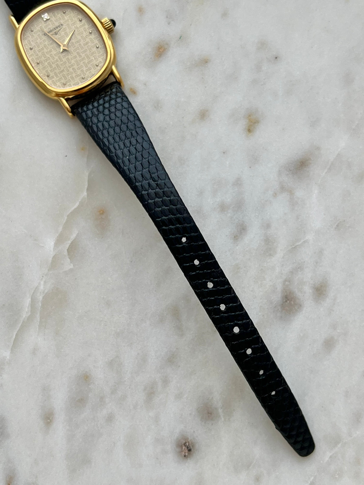 Longines Oblong Patterned Dial Women’s Watch — Leather strap tip and case on marble