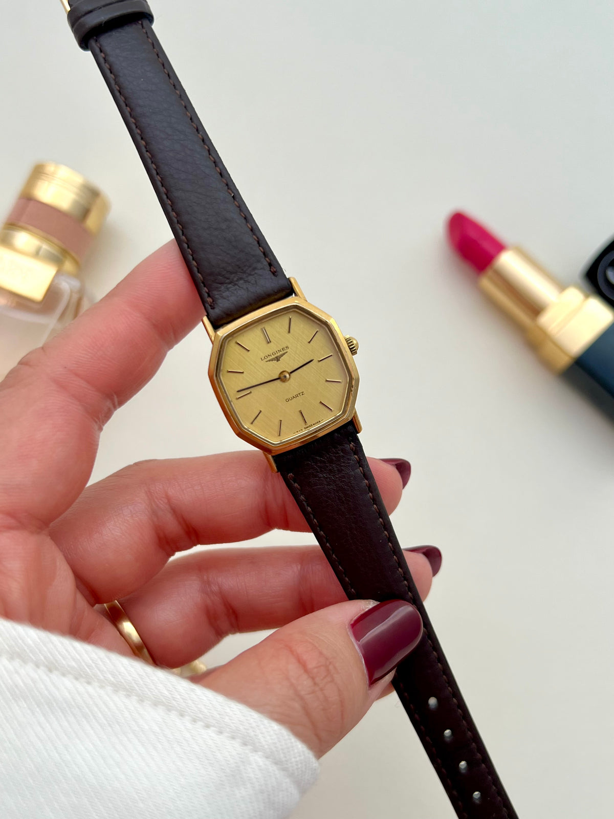 Longines Gold Octagonal Woven Dial watch — held watch