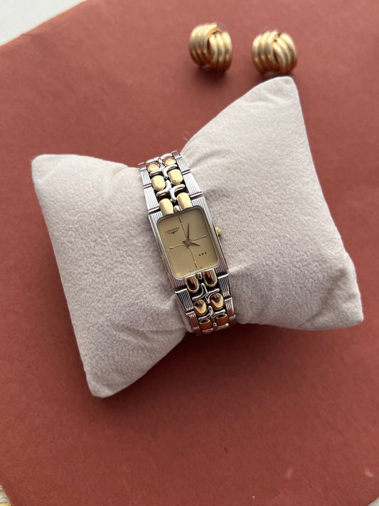 Front view of the Longines QWR two-tone ladies watch with a champagne vertically patterned dial.