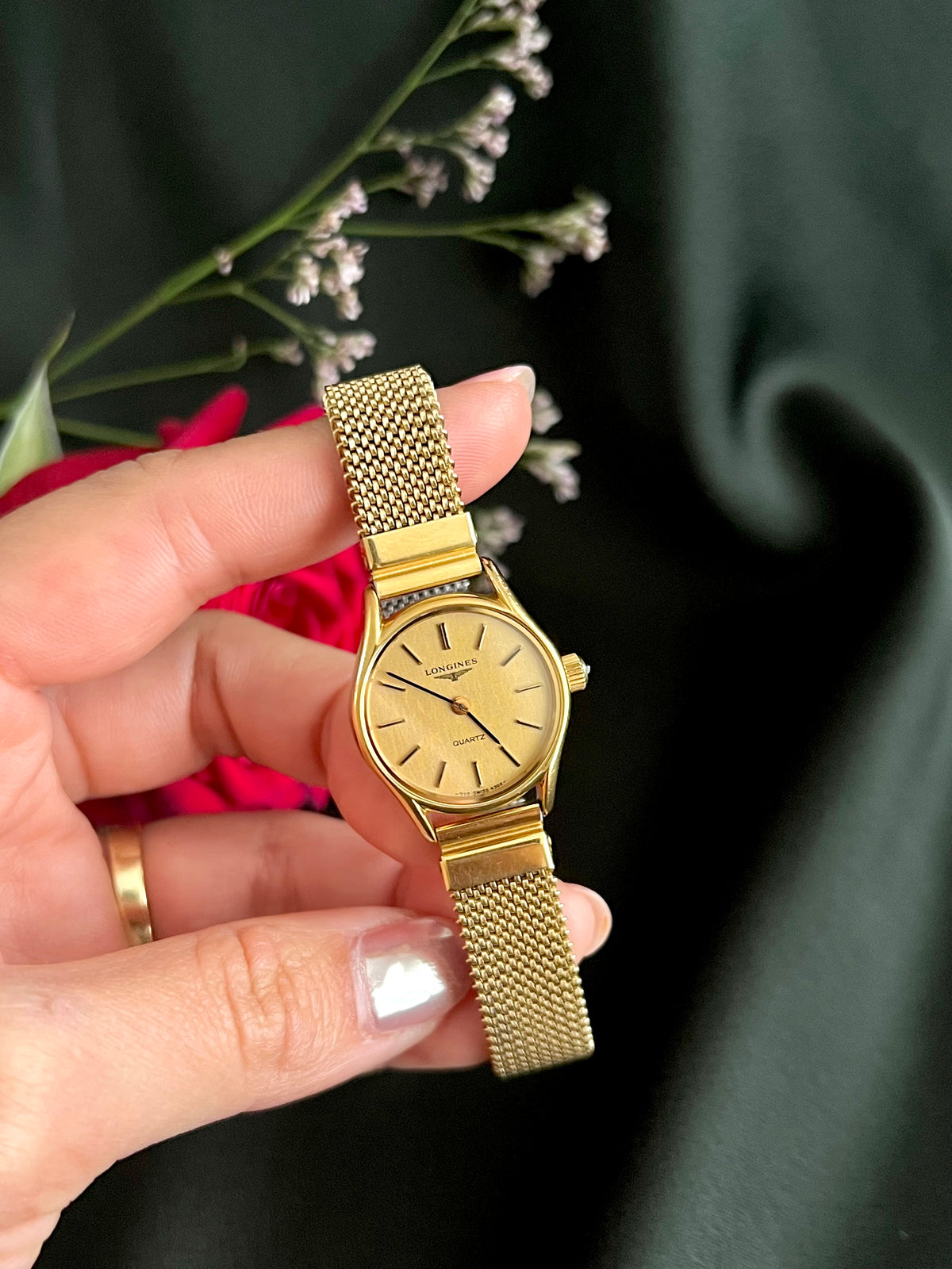 Longines Champagne Bracelet Women’s Watch — dial and expansion bracelet held in hand