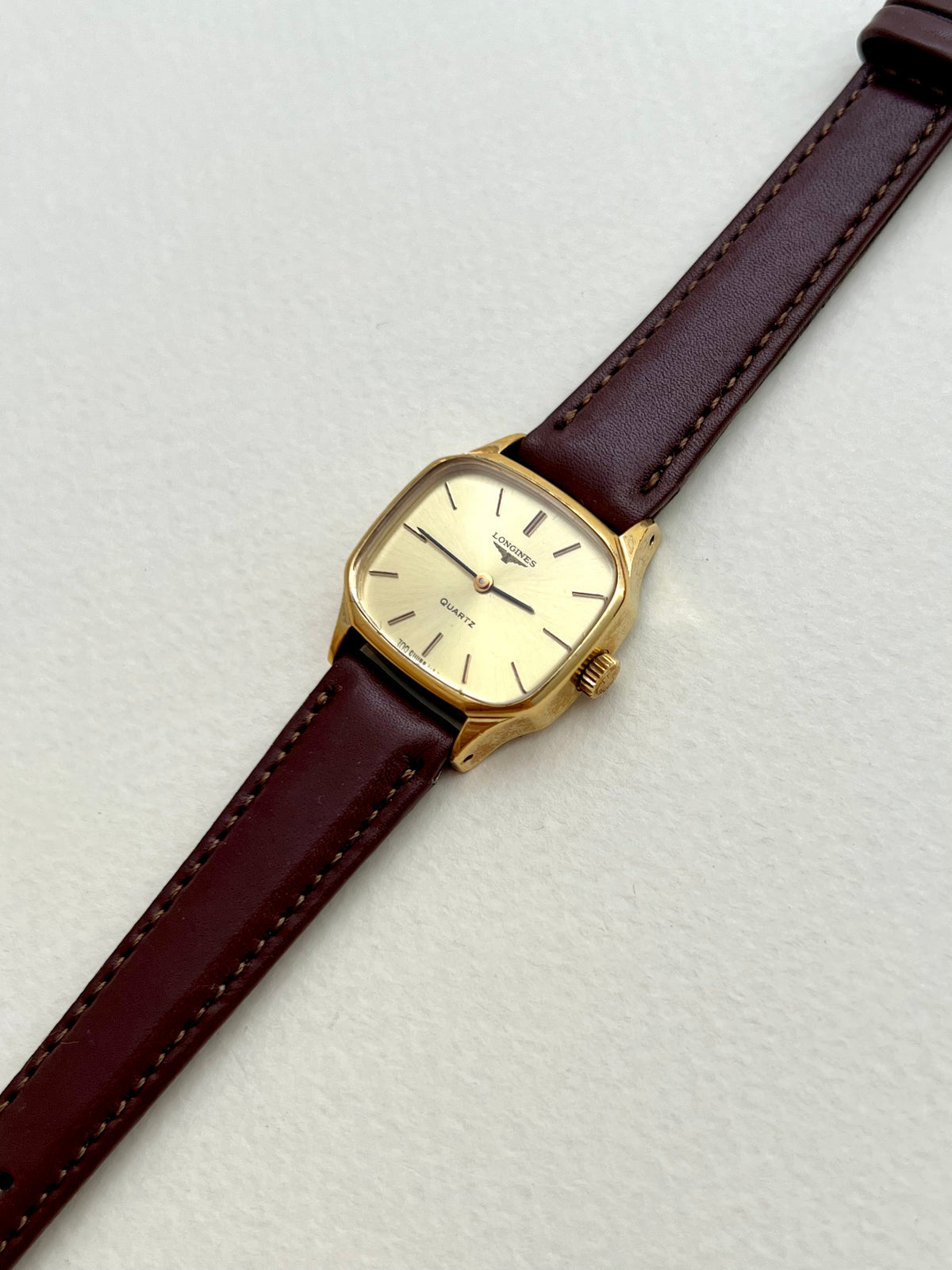 Close-up of the brown aftermarket strap and buckle on the Longines soft octagonal watch.