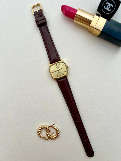 Side profile of the Longines soft octagonal case and signed gold-tone crown.
