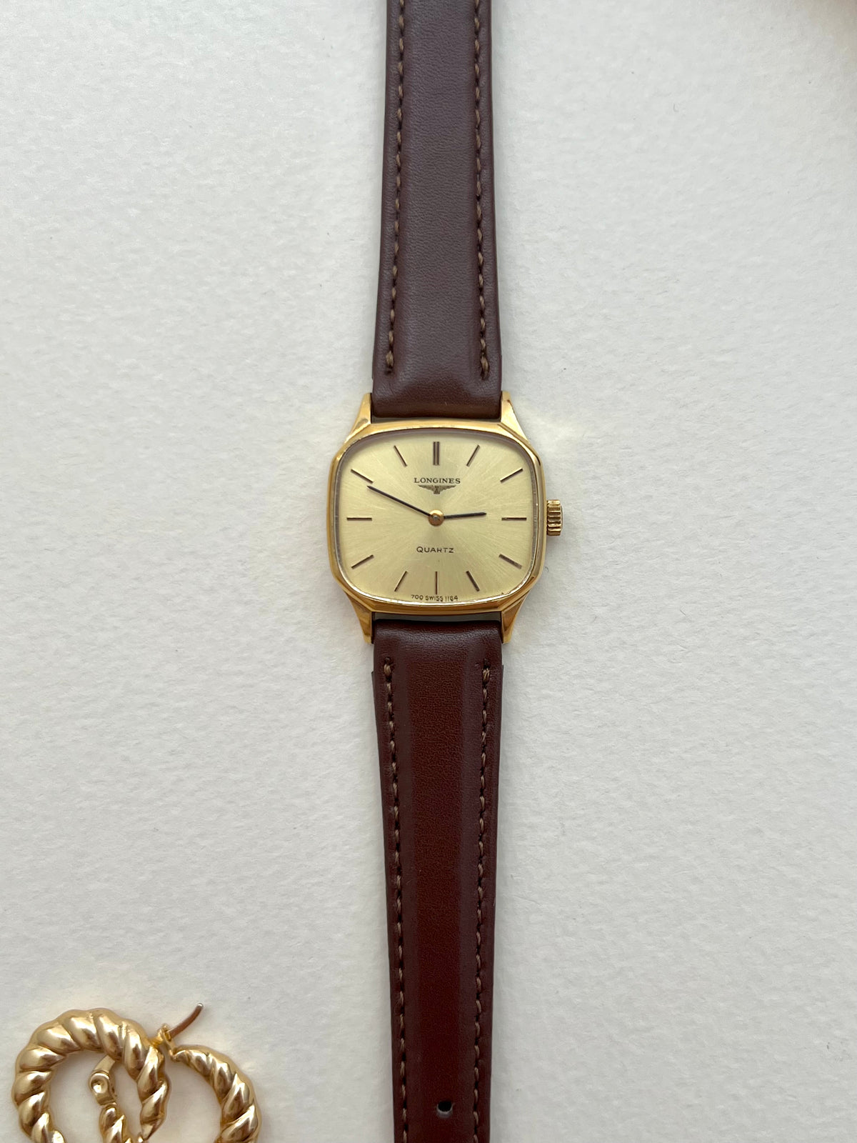 Longines soft octagonal ladies watch photographed with a display box.