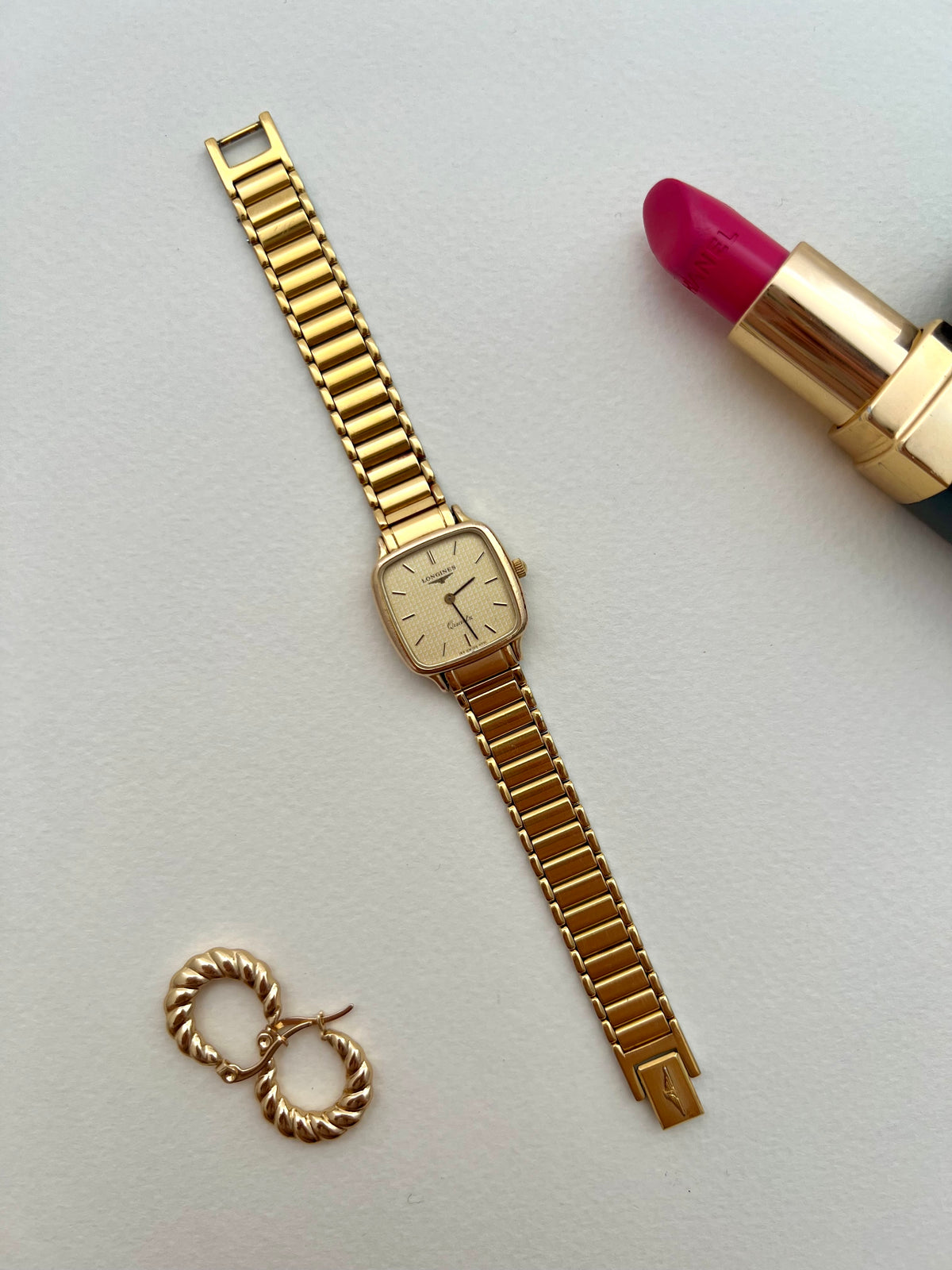 Close-up of the Longines waffle-texture dial, gold-tone bezel and slim baton hour markers.
