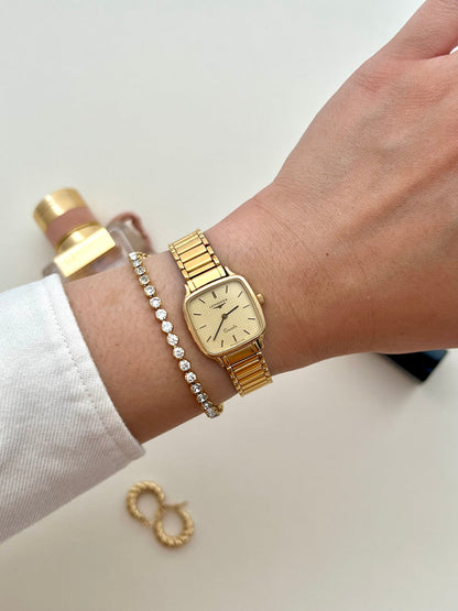 Front view of the vintage Longines soft-square gold-tone ladies watch with pale waffle-texture dial.