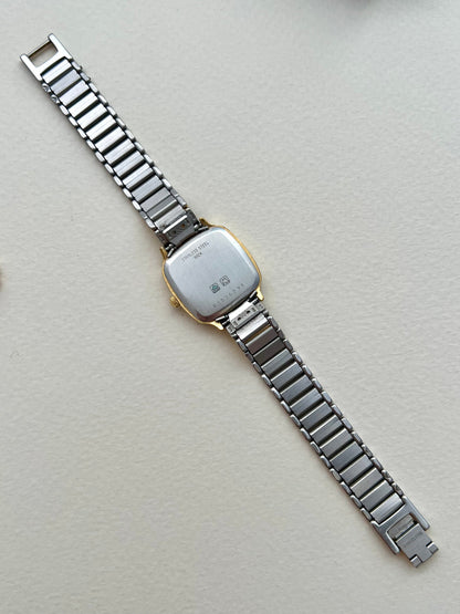Full front view of the Longines soft-square ladies watch with gold-tone bracelet and pale textured dial.