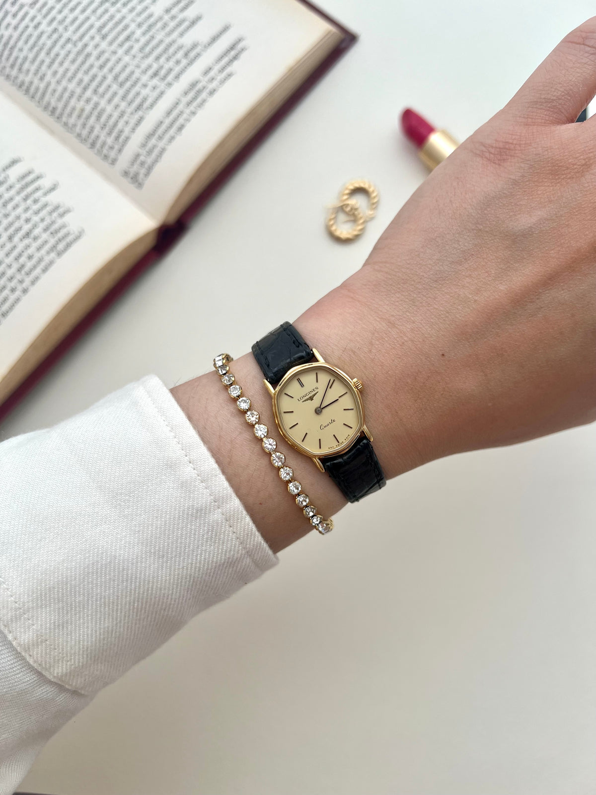 Close-up of the Longines soft tonneau cream dial with slim gold-tone baton markers.