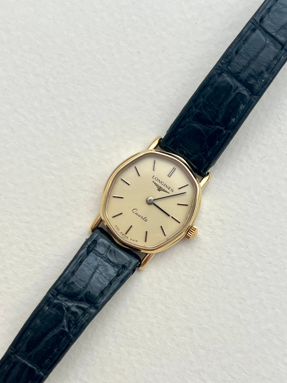 Caseback detail of the vintage Longines soft tonneau gold-tone watch.
