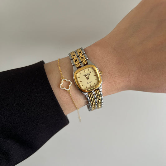 Longines ladies two-tone bracelet watch with champagne dial and gold-tone cushion case.