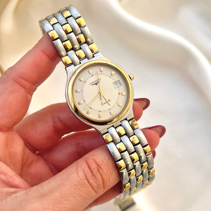 Longines women’s watch with textured champagne dial, date window and two tone bracelet